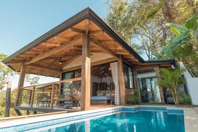 an open pavilion with a pool in front of a house at Vista del Alma Boutique - Adult Only in Santa Teresa Beach