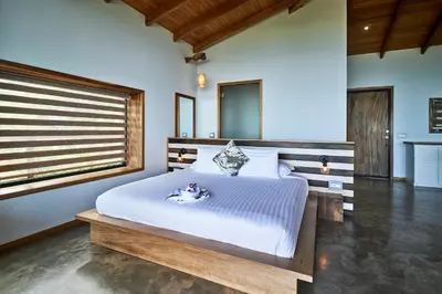 a bedroom with a large white bed with a window at Vista del Alma Boutique - Adult Only in Santa Teresa Beach