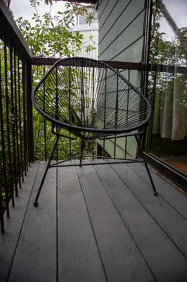 a metal bench sitting on a porch at Quality Cabins Monteverde in Monteverde Costa Rica
