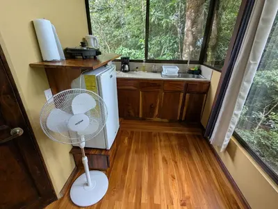 a kitchen with a fan in a tiny house at Quality Cabins Monteverde in Monteverde Costa Rica