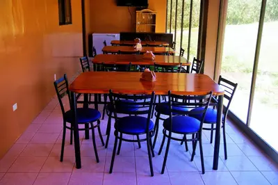 a wooden table and chairs in a room with a window at Nafre House B&B Monteverde in Monteverde Costa Rica
