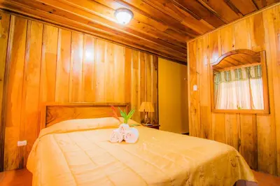 a bedroom with a bed with two towels on it at Hotel Cipreses in Monteverde Costa Rica