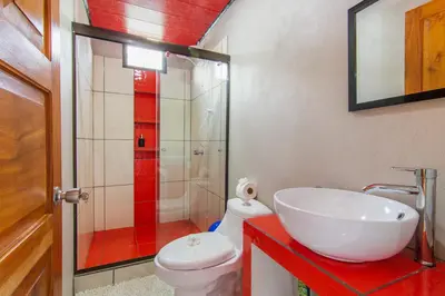 a bathroom with a white sink and a toilet at Casa Monarca II - Monteverde in Monteverde Costa Rica