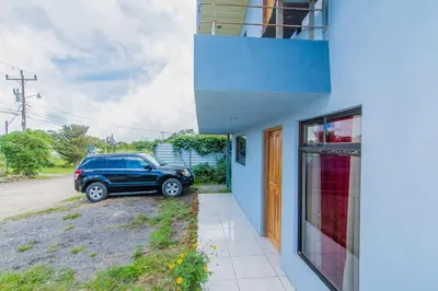 a blue house with a car parked outside of it at Casa Monarca II - Monteverde in Monteverde Costa Rica