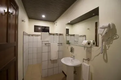 a bathroom with a sink and a shower at Tirimbina Rainforest Lodge in Sarapiquí