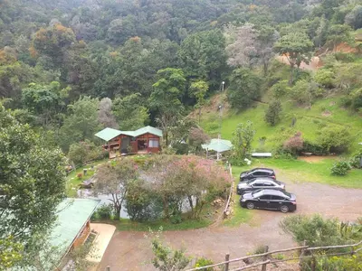 a group of cars parked in front of a house at Las Cataratas Lodge in San Gerardo de Dota