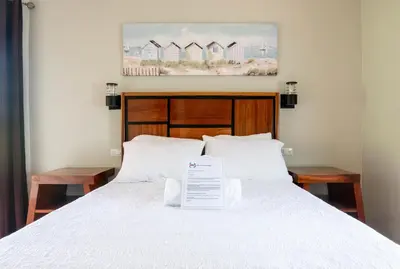 a bedroom with a bed with a sign on it at Bongo - Adults Only in Manuel Antonio