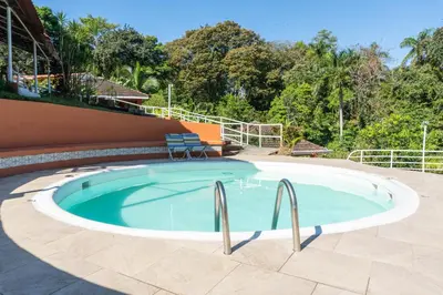 a large swimming pool with two chairs in it at Bongo - Adults Only in Manuel Antonio
