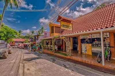 a street with shops on the side of the road at El Sano Banano Beachside Hotel in Montezuma