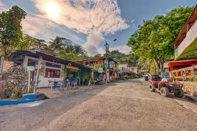 a street in a small town with a dirt road at El Sano Banano Beachside Hotel in Montezuma