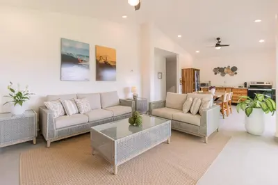 a living room with two couches and a coffee table at Hotel Santa Teresa by the Beach in Santa Teresa Beach