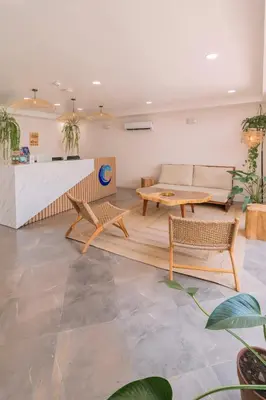a living room with a couch and a table at Hotel Santa Teresa by the Beach in Santa Teresa Beach