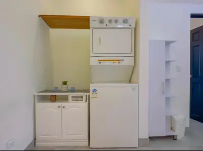 a small kitchen with a stove and a refrigerator at Gorgeous Ocean View Private home, 4 bedrooms with en suite, private plunge pool in Coco