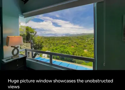 a room with a large window with a view of atyard at Gorgeous Ocean View Private home, 4 bedrooms with en suite, private plunge pool in Coco