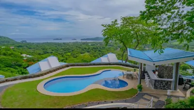 an aerial view of a house with a swimming pool at Gorgeous Ocean View Private home, 4 bedrooms with en suite, private plunge pool in Coco