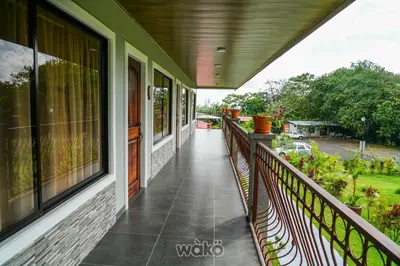 a balcony of a house with a fence at Campos Arenal Hotel in Fortuna
