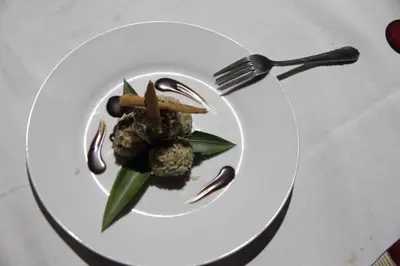 a white plate with food on a table with a fork at Isla Violin Eco-Lodge in Isla Violin