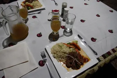 a white table with a plate of food and drinks at Isla Violin Eco-Lodge in Isla Violin