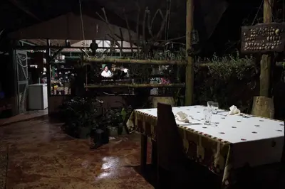 a dining room with a table and people in the background at Isla Violin Eco-Lodge in Isla Violin