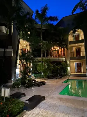 a resort with a swimming pool in front of a building at Macaws Ocean Club Apartamento # 18 in Jacó