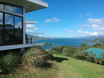 a house with a view of the water at Hotel Laguna Arenal in Unión