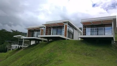 a house sitting on top of a hill at Hotel Laguna Arenal in Unión