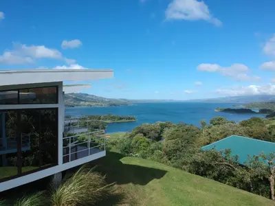 a view of a lake from a house at Hotel Laguna Arenal in Unión