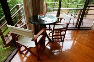 a table and four chairs on a balcony with a table and chairsktop at Tenorio Lodge in Bijagua