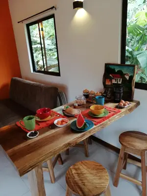 a wooden table with plates of food on it at Aves de Tierras Altas in Bijagua