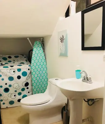 a bathroom with a toilet and a sink at La Buena Vida 2 in Tamarindo