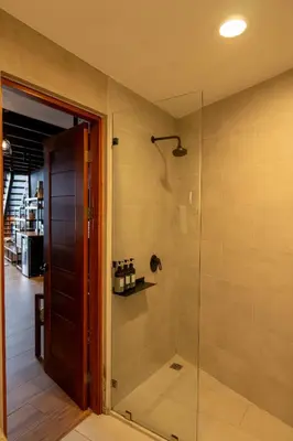 a bathroom with a shower with a glass door at Koora Monteverde a Cloud Forest Hotel by Sandglass in Monteverde Costa Rica
