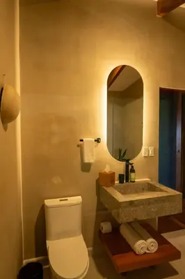a bathroom with a sink and a toilet and a mirror at Koora Monteverde a Cloud Forest Hotel by Sandglass in Monteverde Costa Rica