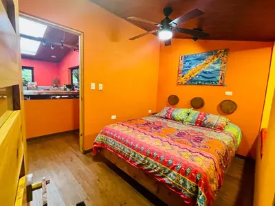 a bedroom with a bed and a ceiling fan at El Sol Monteverde in Monteverde Costa Rica