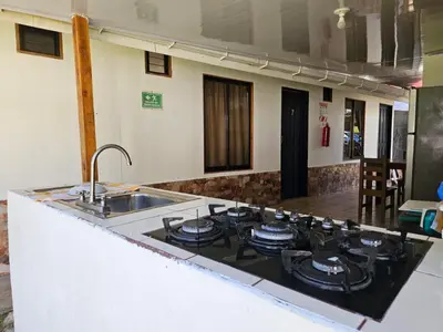 a kitchen with a sink and a stove top oven at Hotel Vive Uvita in Uvita