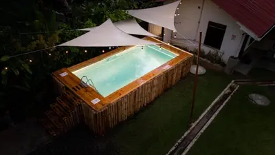 an overhead view of a swimming pool with an umbrella at Hotel Vive Uvita in Uvita