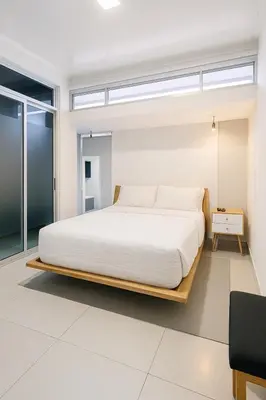 a bedroom with a large bed with white sheets at Costa Rica, San José, Pinares Luxe Apt Near Elite Clinics in San José