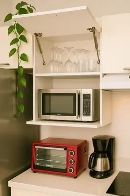 a red microwave on a counter in a kitchen at Costa Rica, San José, Pinares Luxe Apt Near Elite Clinics in San José