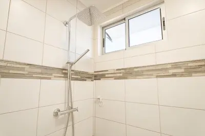 a bathroom with a shower and a window at Costa Rica, San José, Pinares Luxe Apt Near Elite Clinics in San José