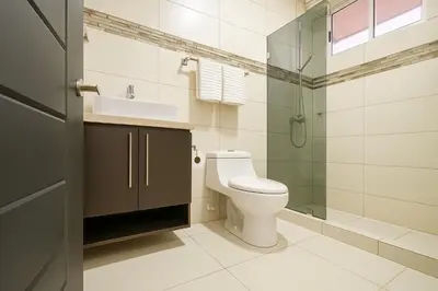 a bathroom with a toilet and a sink and a shower at Costa Rica, San José, Pinares Luxe Apt Near Elite Clinics in San José