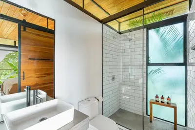a bathroom with a sink and a toilet and a window at The Green House, Santa Teresa - Adults Only in Santa Teresa Beach