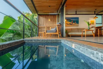 a house with a swimming pool and a living room at The Green House, Santa Teresa - Adults Only in Santa Teresa Beach