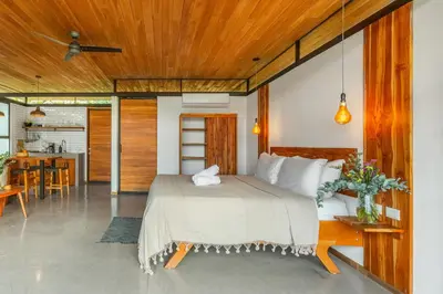 a bedroom with a bed and a dining room at The Green House, Santa Teresa - Adults Only in Santa Teresa Beach