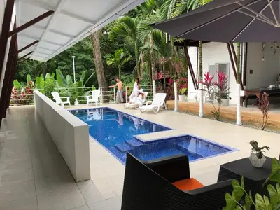 a swimming pool in the middle of a resort at Ballena Dorada Lodge in Uvita