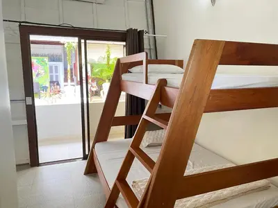 a group of bunk beds in a room with a door at Ballena Dorada Lodge in Uvita