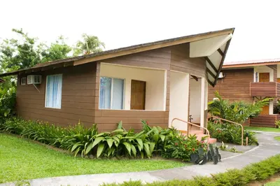 a small house with a garden in front of it at Hotel Eco Arenal in Fortuna