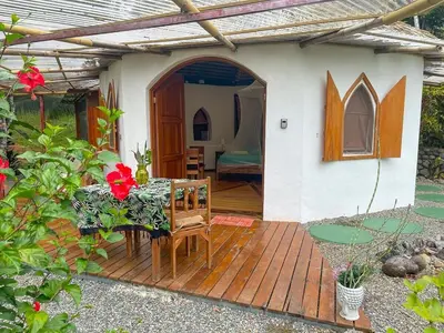 a small house with a table and chairs on a wooden deck at Casa Romantica in Platanillo