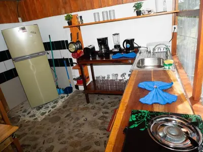 a kitchen with a counter with a sink and a refrigerator at Casa Romantica in Platanillo
