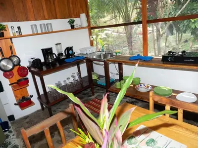 a kitchen with a table and a sink in a room at Casa Romantica in Platanillo
