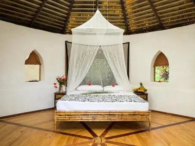 a bedroom with a bed with a canopy at Casa Romantica in Platanillo