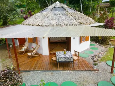a small hut with a table and chairs on a deck at Casa Romantica in Platanillo